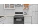 Close-up of kitchen featuring white cabinets, stainless steel range hood, and quartz countertops at 4126 Heron Way # B113, Bradenton, FL 34205