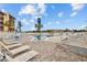 Community swimming pool with ample lounge chairs and a bright blue sky at 4126 Heron Way # B113, Bradenton, FL 34205