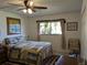 Cozy bedroom featuring a comfortable bed, ceiling fan, and natural light from the window at 4160 Fruitville Rd # 32, Sarasota, FL 34232