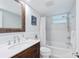 Bathroom with rustic vanity, bathtub, and subway tile at 4320 Falmouth Dr # 301, Longboat Key, FL 34228