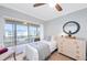 Bedroom with a twin bed, dresser, and sliding door to balcony at 4320 Falmouth Dr # 301, Longboat Key, FL 34228