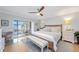 Bright bedroom with king-size bed, access to balcony, and modern dresser at 4320 Falmouth Dr # 301, Longboat Key, FL 34228