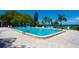 Beautiful community swimming pool surrounded by palm trees and lush landscaping at 4320 Falmouth Dr # 301, Longboat Key, FL 34228