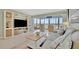 Living room with water views, comfy seating, and built-in entertainment center at 4430 Exeter Dr # 104, Longboat Key, FL 34228