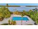 Community pool with lounge chairs and waterfront views at 4430 Exeter Dr # 104, Longboat Key, FL 34228