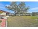 A spacious backyard with a view of the pond and other homes in the community at 4565 Mohican Trl # 129, Sarasota, FL 34233