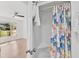 Bathroom boasts a shower with colorful curtains at 4565 Mohican Trl # 129, Sarasota, FL 34233