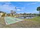 Scenic view of a beautiful community with shuffleboard, a pond, and well-maintained landscaping under a bright, sunny sky at 4565 Mohican Trl # 129, Sarasota, FL 34233