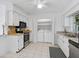 Bright kitchen with white cabinets, stainless steel appliances, and convenient in-unit laundry at 4565 Mohican Trl # 129, Sarasota, FL 34233