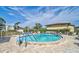 Inviting community pool with clear blue water, surrounded by lounge chairs and manicured landscaping at 4565 Mohican Trl # 129, Sarasota, FL 34233