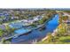 Aerial view of the property showcasing its waterfront location, pool, and proximity to the canal at 4607 Mangrove Point Rd, Bradenton, FL 34210