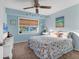 Coastal-themed bedroom with calming blue walls, a ceiling fan, and bright natural light at 4607 Mangrove Point Rd, Bradenton, FL 34210