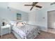 Bright bedroom with a ceiling fan, closet space, and tranquil blue walls at 4607 Mangrove Point Rd, Bradenton, FL 34210