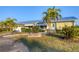 Charming house with a metal roof, lush landscaping, and inviting curb appeal at 4607 Mangrove Point Rd, Bradenton, FL 34210