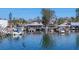 Picturesque waterfront scene with a restaurant and boats docked along the peaceful water's edge at 4607 Mangrove Point Rd, Bradenton, FL 34210