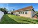 Spacious backyard featuring lush green grass, a well-maintained fence, and a cozy seating area at 4616 Park Acres Dr, Bradenton, FL 34207