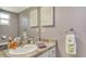 Bathroom featuring a single sink vanity, framed mirror, and decorative lighting at 4616 Park Acres Dr, Bradenton, FL 34207