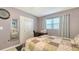 Comfortable bedroom featuring tiled floors, a bed with a quilt, and a white closet door at 4616 Park Acres Dr, Bradenton, FL 34207