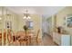 Cozy dining area with a wooden table set for four, adjacent to the living room at 4616 Park Acres Dr, Bradenton, FL 34207