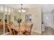 Dining area features a wood table and chairs, a pass-through to the kitchen and mirrored walls at 4616 Park Acres Dr, Bradenton, FL 34207