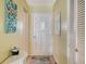 Home entryway featuring wood-look floors, white front door, and closet with louvered doors at 4616 Park Acres Dr, Bradenton, FL 34207