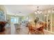 Bright living room features light wood floors, light-colored walls and sliding doors to the lanai at 4616 Park Acres Dr, Bradenton, FL 34207