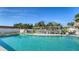 Inviting community pool featuring clear blue water and a covered seating area, perfect for relaxing at 4616 Park Acres Dr, Bradenton, FL 34207