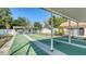 Well-maintained shuffleboard courts with shaded seating, perfect for outdoor recreation and socializing at 4616 Park Acres Dr, Bradenton, FL 34207