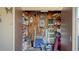 Packed storage room with shelving, a ladder, cleaning supplies, and many personal items at 4616 Park Acres Dr, Bradenton, FL 34207