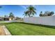 Well-maintained yard with lush green grass, a white fence, and mature palm trees at 4616 Park Acres Dr, Bradenton, FL 34207