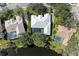 An aerial view of a home with a screened-in pool and lush backyard adjacent to a pond at 4749 Antler Trl, Sarasota, FL 34238