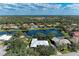 An aerial view showing the property with a beautiful lake view, surrounded by mature trees at 4749 Antler Trl, Sarasota, FL 34238