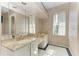 Bathroom with double vanity, a large mirror, and a window at 4749 Antler Trl, Sarasota, FL 34238