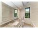 Bathroom featuring granite countertops, a large mirror, and plenty of natural light from dual windows at 4749 Antler Trl, Sarasota, FL 34238