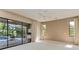 Neutral bedroom with sliding glass doors offering a view of the pool area at 4749 Antler Trl, Sarasota, FL 34238