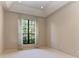 Bedroom with a large window providing ample natural light and neutral carpet at 4749 Antler Trl, Sarasota, FL 34238