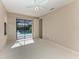 Bedroom with large sliding doors that open to a screened-in pool at 4749 Antler Trl, Sarasota, FL 34238