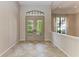 Light-filled foyer featuring tiled flooring, double doors, and decorative windows at 4749 Antler Trl, Sarasota, FL 34238