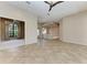 Open living room with tile floors, ceiling fan, and lots of natural light at 4749 Antler Trl, Sarasota, FL 34238