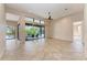 Spacious living room with tile flooring and large sliding doors leading to the outdoor patio at 4749 Antler Trl, Sarasota, FL 34238