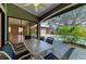 Covered patio with pool view, dining table, and screened enclosure for outdoor entertaining at 4749 Antler Trl, Sarasota, FL 34238