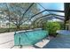 Screened-in pool and spa are surrounded by tile and landscaping at 4749 Antler Trl, Sarasota, FL 34238