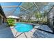 Screened-in pool and spa are surrounded by tile and landscaping at 4749 Antler Trl, Sarasota, FL 34238