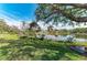 A serene water view from a beautiful property, complete with lush greenery and mature trees at 4749 Antler Trl, Sarasota, FL 34238