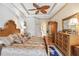 Main bedroom with large bed, wood dresser and ceiling fan at 4921 Woodhurst Dr, Sarasota, FL 34243