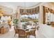 Breakfast nook with glass table and wicker chairs overlooking the pool at 4921 Woodhurst Dr, Sarasota, FL 34243