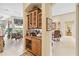 Butlers pantry with glass-front cabinetry, wine rack, and granite countertop at 4921 Woodhurst Dr, Sarasota, FL 34243