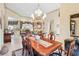 Bright dining room with elegant chandelier and hardwood floors at 4921 Woodhurst Dr, Sarasota, FL 34243