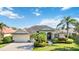 Single-story home with tile roof, attached garage, and manicured landscaping at 4921 Woodhurst Dr, Sarasota, FL 34243