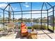 Peaceful screened patio with lake view and seating at 4921 Woodhurst Dr, Sarasota, FL 34243